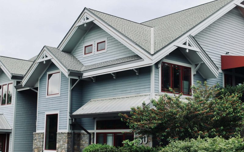 Charming blue house exterior with modern architectural features in Asheville, NC.